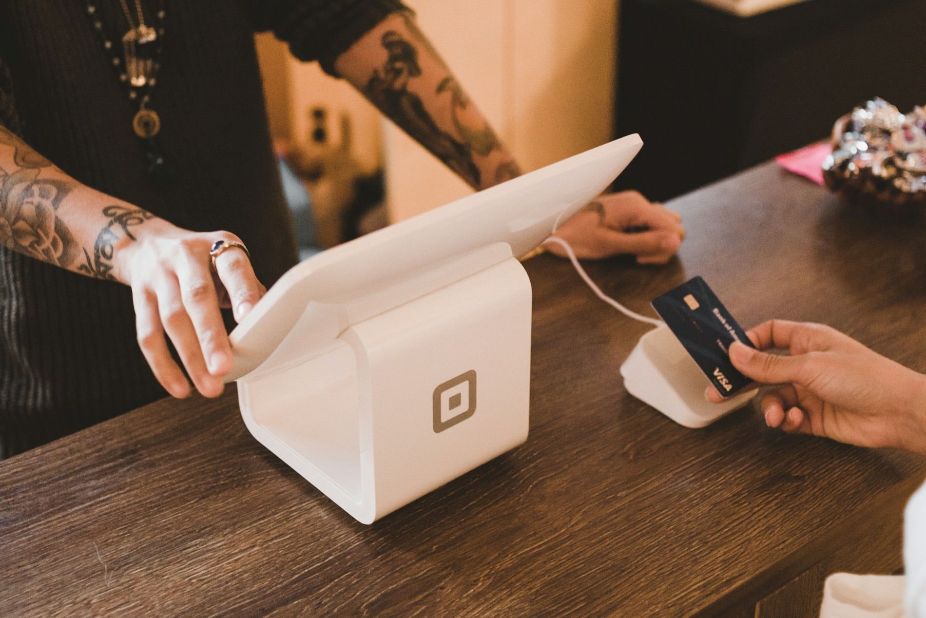 A card held to a countertop payment terminal