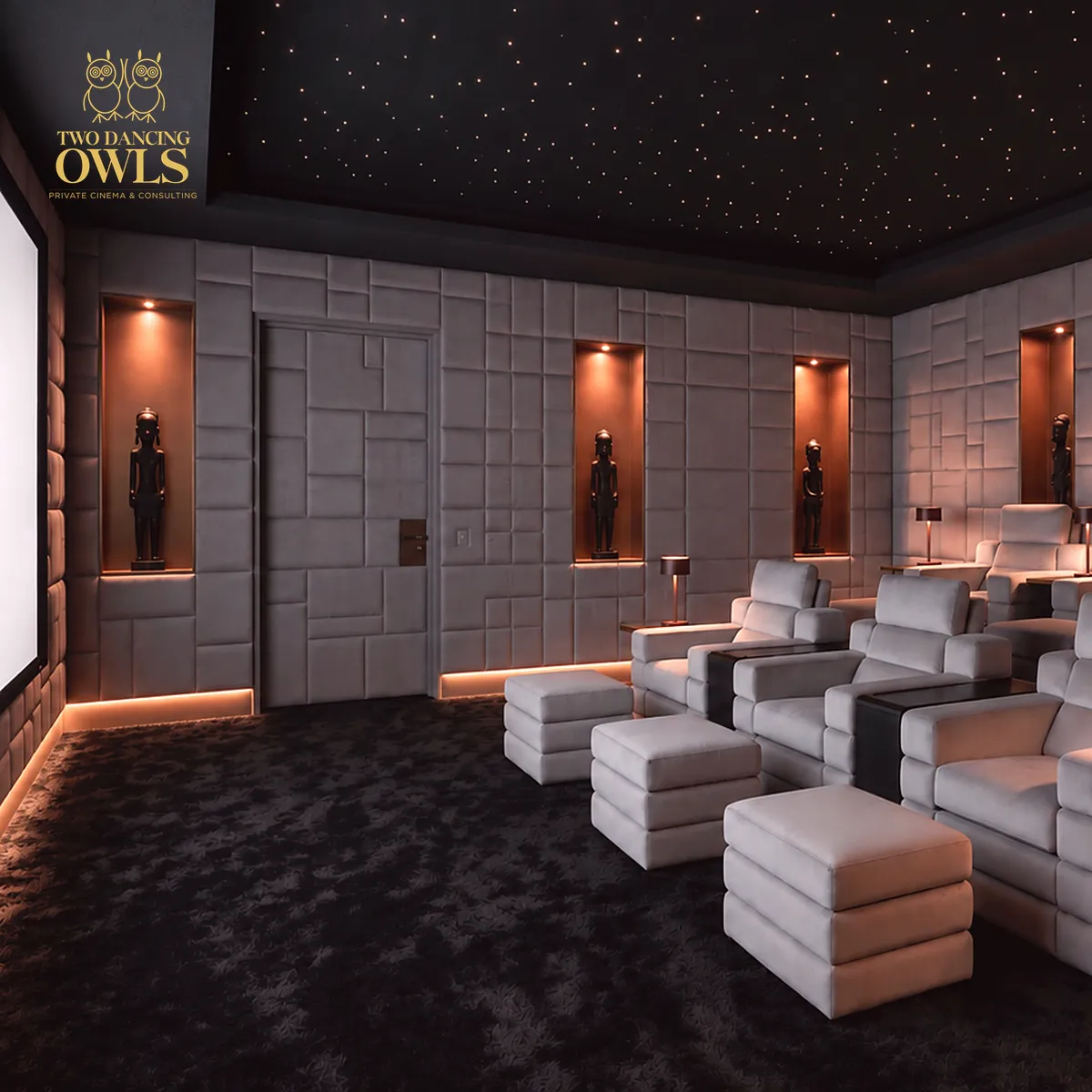 Private cinema in pale grey velvet with a star ceiling, African sculptures in lit niches and the Two Dancing Owls logo